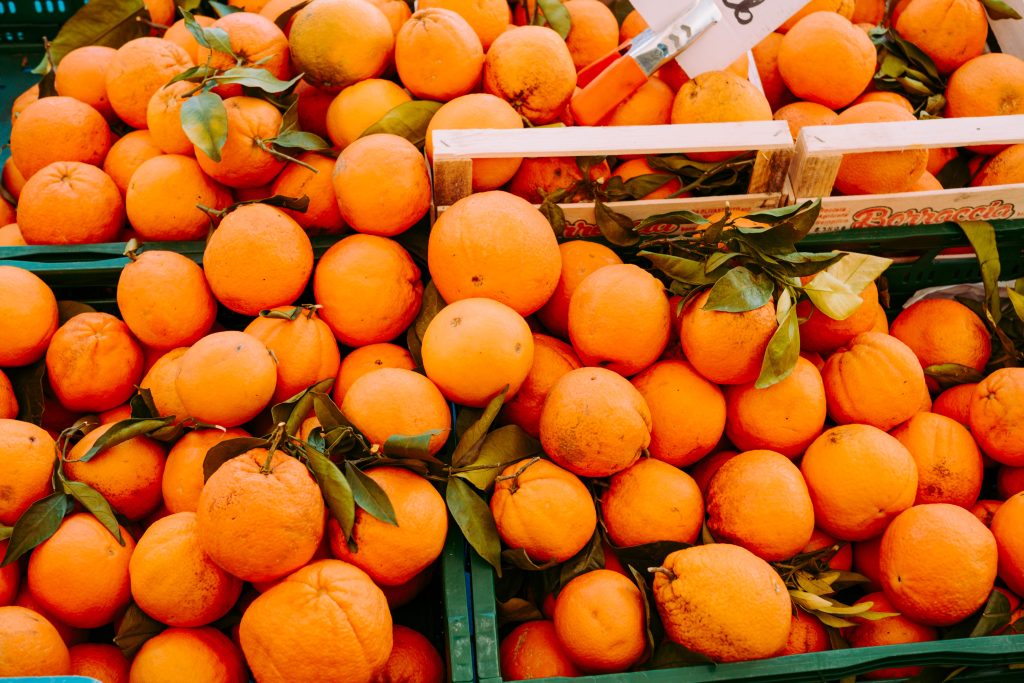 Close up of bright oranges and citrus fruit at outdoor street market in Ixelles Brussels