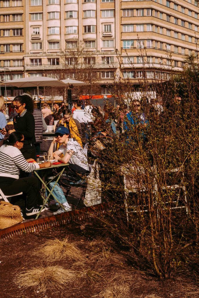 Busy café terrace in Ixelles Brussels with people enjoying drinks in the sun
