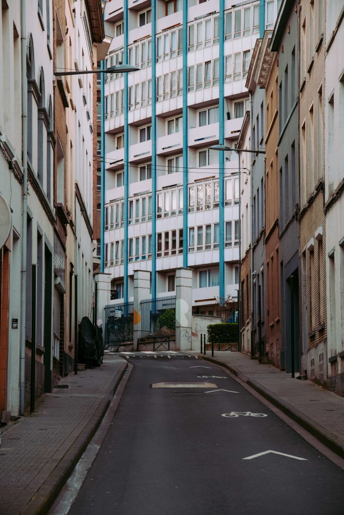 Aged residential building behind a turquoise wall in Brussels